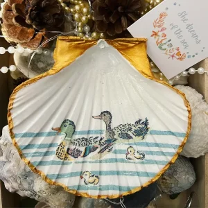 shell trinket dish with blue stripes and gold trim.