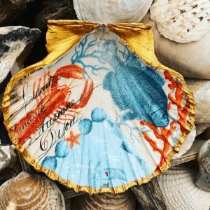 a red lobster painted onto a sea shell