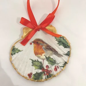 a scallop shell painted with a red robin