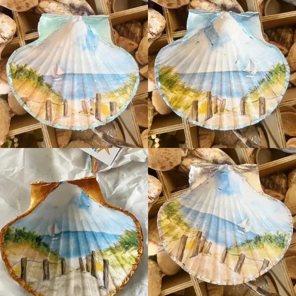 a sailing boat at sea printed on a scallop shell